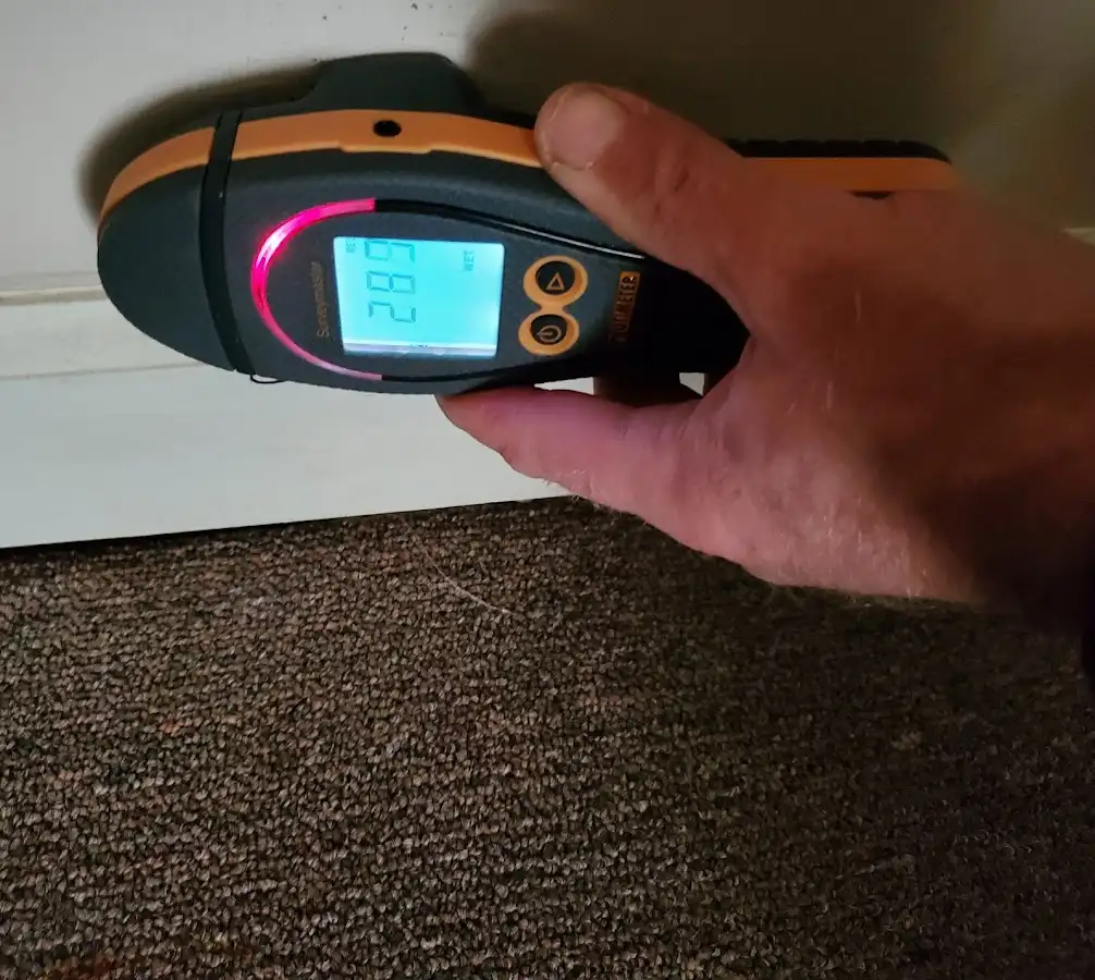 Moisture detection at baseboard during Storm Damage Restoration in Lakehills